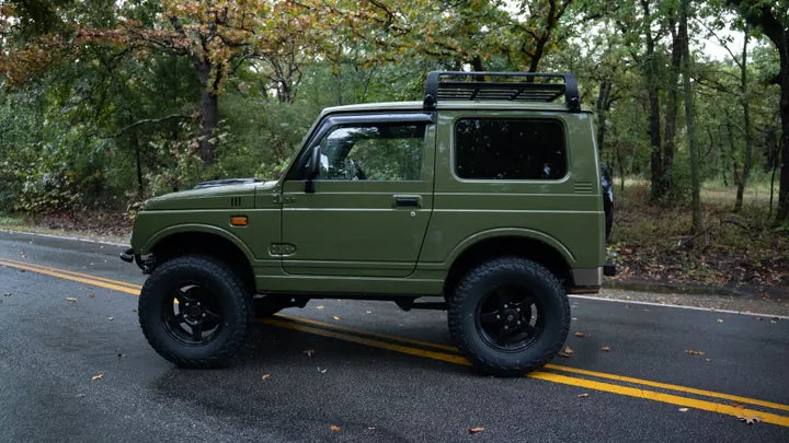 Side profile of the green Suzuki Jimny facing left