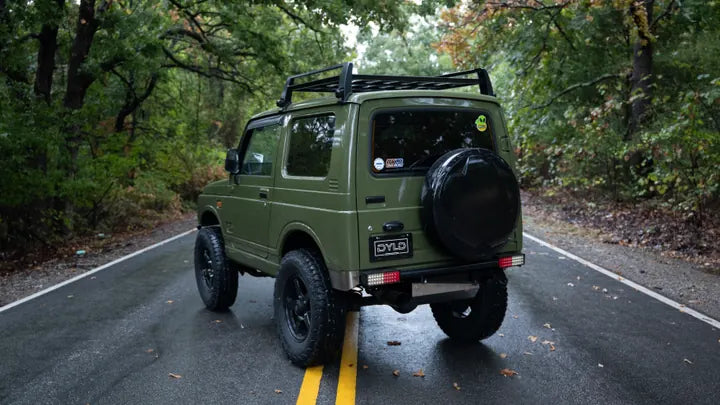 Rear three-quarter view of the green Suzuki Jimny