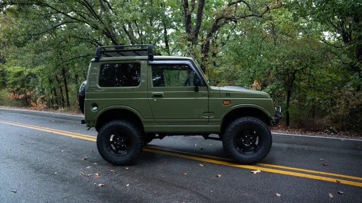 Side profile of the green Suzuki Jimny facing right