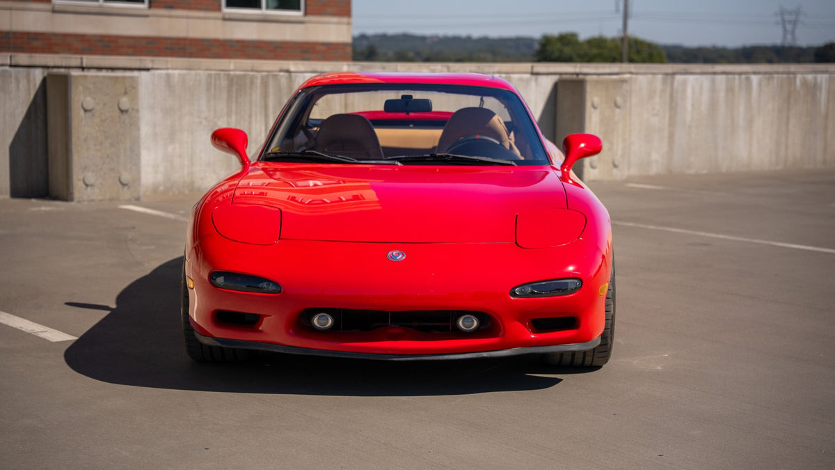 Straight-on front view of the red RX-7